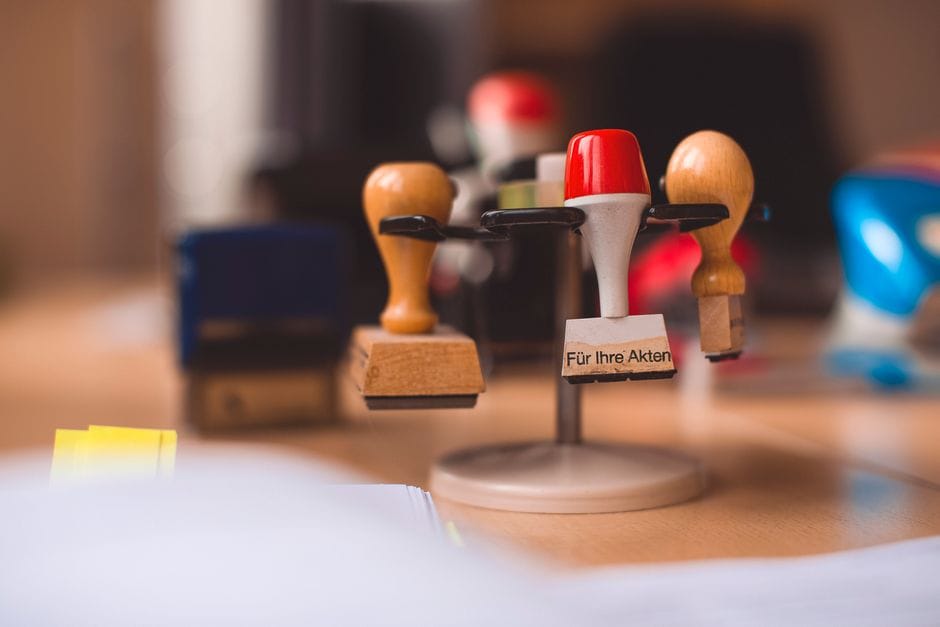 How to Remove a Watermark from a PDF A variety of rubber stamps in selective focus on a wooden table indoors.