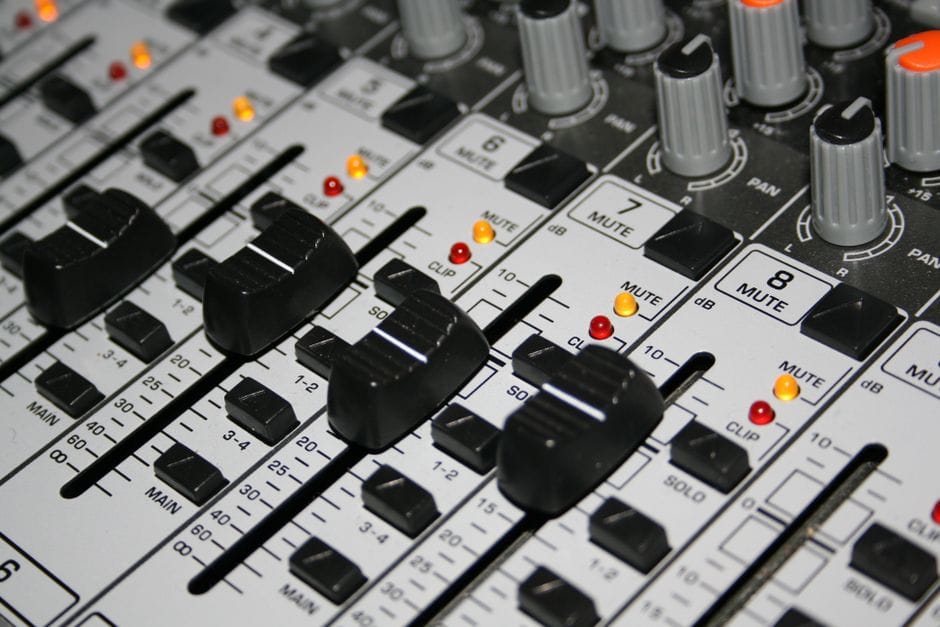 How to Compress a PDF Without Losing Quality Detailed shot of a professional audio mixer with knobs and sliders illuminated by indicator lights.