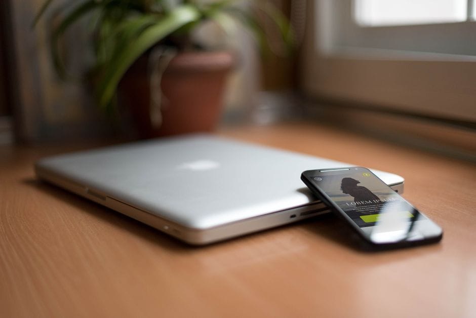 From Phone Photo to Perfect PDF: A Step-by-Step Scanning Workflow Close-up of a silver laptop and smartphone on a wooden desk, capturing modern work essentials.