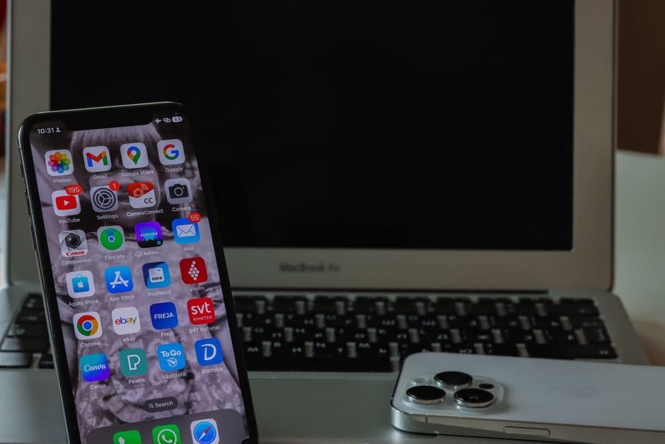 PDF File Size Limits: Why Uploads Get Rejected and How to Fit Under Any Limit Close-up of a smartphone and laptop on a desk, displaying productivity and connectivity.