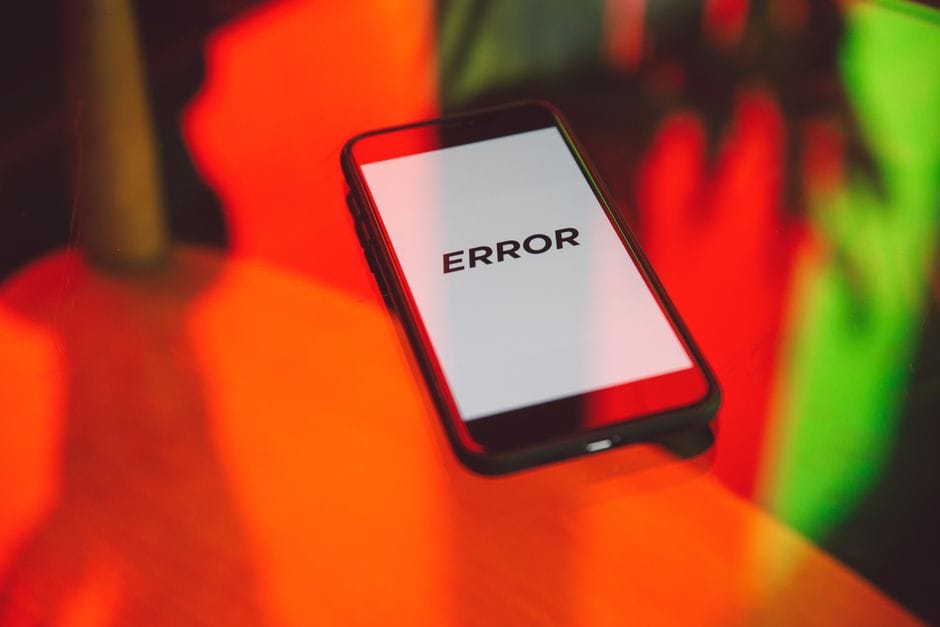 How to Split a Large PDF Into Smaller Files Under 5MB A smartphone displaying an 'ERROR' message surrounded by vibrant red and green reflections indoors.