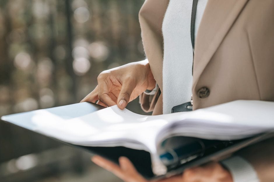 How to Replace a Page in a PDF (Without Editing Software) Crop faceless female entrepreneur in stylish jacket reading important documents in black folder