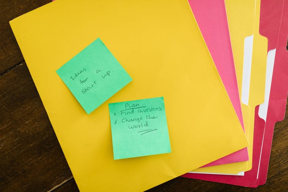 How to Merge, Reorder, and Organize PDF Files (Complete Guide) Startup ideas on sticky notes with colorful folders on a wooden surface, an inspiring organizational theme.