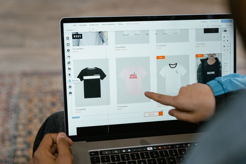 Insert vs Merge PDF: Which Tool Should You Use? A person points to t-shirt options in an online store on a laptop screen.