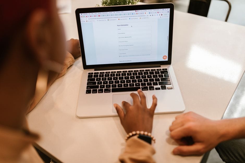 PDF File Size Limits: Why Uploads Get Rejected and How to Fit Under Any Limit Two adults working together on a laptop displaying an online form, indoors.