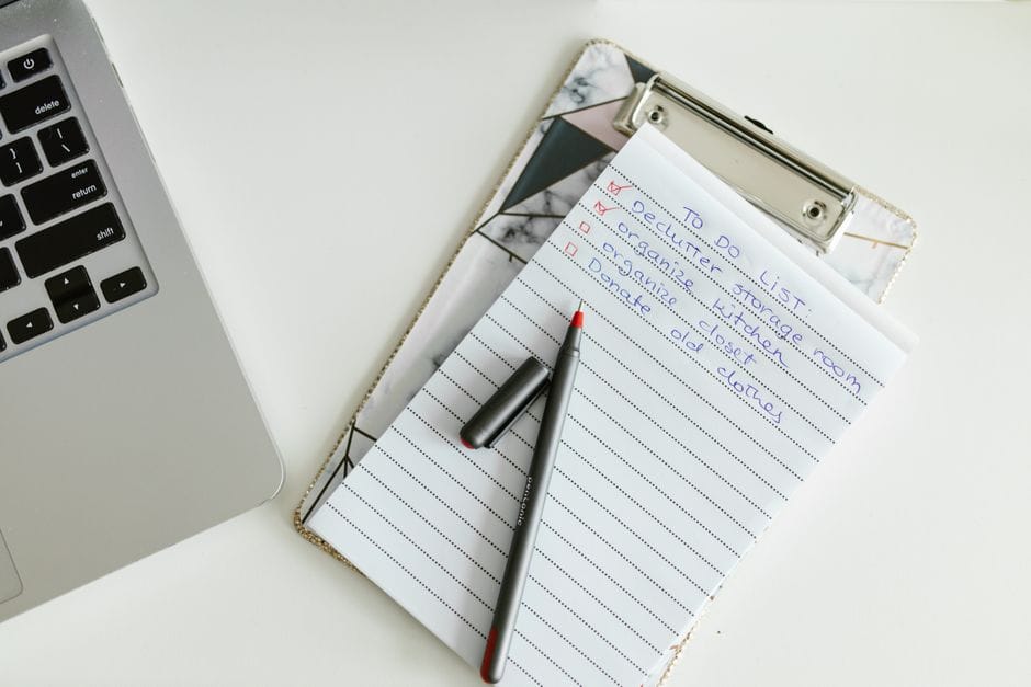 The Final Check: 12 Things to Verify Before You Send Any PDF A neatly organized to-do list on a clipboard next to a laptop and pen, conveying productivity.