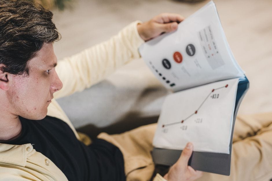 The Final Check: 12 Things to Verify Before You Send Any PDF Adult man reviewing business charts in a document, focused on growth strategy.